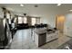 Open concept kitchen with granite countertops, white cabinets, stainless appliances, and tile flooring at 5636 W Jackalope Ln, Laveen, AZ 85339