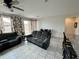 Spacious living room boasts tile flooring, neutral paint, and a sliding glass door to the backyard at 5636 W Jackalope Ln, Laveen, AZ 85339