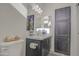 Modern bathroom featuring stylish vanity with a marble countertop and decorative cabinet at 7750 E Broadway Rd # 723, Mesa, AZ 85208