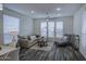 Bright living room featuring a comfortable sofa, ceiling fan, and large windows for natural light at 7750 E Broadway Rd # 723, Mesa, AZ 85208