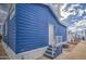 Side of a blue house with an entry door, showing the home's tidy surroundings at 7750 E Broadway Rd # 723, Mesa, AZ 85208