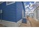 Side of a blue house with an entry door, showing the home's tidy surroundings at 7750 E Broadway Rd # 723, Mesa, AZ 85208