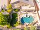Inviting aerial view of a private backyard featuring a sparkling pool, lush landscaping, and patio, perfect for outdoor living at 16847 S 13Th Way, Phoenix, AZ 85048