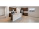 Modern kitchen with island, stainless steel appliances, and dark brown cabinets at 17831 W Encinas Ln, Goodyear, AZ 85338