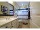 Clean bathroom with white vanity, shower, and decorative accents at 2541 E Carob Dr, Gilbert, AZ 85298