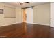 Bright bedroom with hardwood floors and a barn door to the bathroom at 2541 E Carob Dr, Gilbert, AZ 85298