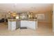 Island kitchen with granite countertops and stainless steel appliances at 2541 E Carob Dr, Gilbert, AZ 85298