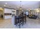 Open kitchen with island and breakfast bar, granite countertop at 2541 E Carob Dr, Gilbert, AZ 85298