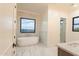 Bathroom with soaking tub, marble tile and a view at 3888 E Weston Ln, San Tan Valley, AZ 85140