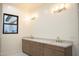 Bright bathroom featuring double sinks, a marble countertop, and gold fixtures for a luxurious feel at 3888 E Weston Ln, San Tan Valley, AZ 85140