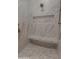 Newly tiled shower with a marble bench, rainfall shower head, and built-in shelving at 3888 E Weston Ln, San Tan Valley, AZ 85140