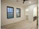 Spacious bedroom with light wood flooring, black trimmed windows and ensuite bathroom at 3888 E Weston Ln, San Tan Valley, AZ 85140