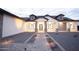 Stunning exterior with brick accents, a modern front door, and desert landscaping with walkway lighting at 3888 E Weston Ln, San Tan Valley, AZ 85140