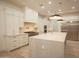 Gourmet kitchen featuring custom cabinets, quartz counters, stainless appliances, and designer lighting at 3888 E Weston Ln, San Tan Valley, AZ 85140