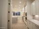 Open kitchen design with a large island, modern appliances, and wood tile flooring at 3888 E Weston Ln, San Tan Valley, AZ 85140