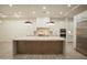 Bright kitchen featuring an island with a quartz countertop, designer lighting, and stainless appliances at 3888 E Weston Ln, San Tan Valley, AZ 85140