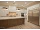 Gourmet kitchen featuring custom cabinetry, quartz countertops, and stainless steel appliances at 3888 E Weston Ln, San Tan Valley, AZ 85140