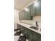 Well-appointed laundry room with green cabinets, stainless steel sink, and marble counter at 3888 E Weston Ln, San Tan Valley, AZ 85140