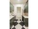 A glimpse of a stunning laundry room with checkered floors and ample cabinet space at 3888 E Weston Ln, San Tan Valley, AZ 85140