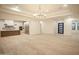 Open-concept space with a chandelier, tile floors, and an adjacent kitchen featuring stainless appliances at 3888 E Weston Ln, San Tan Valley, AZ 85140