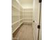Walk-in pantry with ample shelving space and wood tile flooring at 3888 E Weston Ln, San Tan Valley, AZ 85140