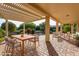 Covered outdoor patio with a dining table and comfortable seating area for relaxing and entertaining at 16513 W Windsor Ave, Goodyear, AZ 85395