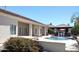 Resort-style backyard with swimming pool, fountain, outdoor kitchen, and mature landscaping at 18029 W San Miguel Ave, Litchfield Park, AZ 85340
