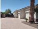 Spacious driveway with brick pavers leads to a two-car garage offering ample parking space at 18029 W San Miguel Ave, Litchfield Park, AZ 85340