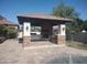 Gorgeous outdoor kitchen featuring stone accents, a built-in grill, and ample counter space at 18029 W San Miguel Ave, Litchfield Park, AZ 85340