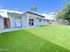 Backyard with new synthetic grass and covered patio at 2213 E Janice Way, Phoenix, AZ 85022