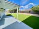 Backyard with synthetic grass and covered patio at 2213 E Janice Way, Phoenix, AZ 85022