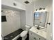 Stylish bathroom, featuring a walk-in shower with geometric tile and black accents at 2213 E Janice Way, Phoenix, AZ 85022