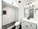 Stylish bathroom featuring a tiled walk-in shower and modern vanity with black hardware at 2213 E Janice Way, Phoenix, AZ 85022