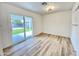 Bright bedroom with wood-look flooring, a sliding glass door leading to the backyard, and natural light at 2213 E Janice Way, Phoenix, AZ 85022