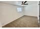 Bedroom featuring neutral carpet, a modern ceiling fan, and a bright window at 2213 E Janice Way, Phoenix, AZ 85022