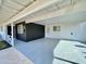 Spacious covered carport featuring painted concrete, a storage room, and access to the home at 2213 E Janice Way, Phoenix, AZ 85022