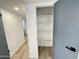Hallway view highlighting the wood-look tile flooring and a linen closet at 2213 E Janice Way, Phoenix, AZ 85022