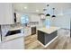 Modern kitchen featuring white cabinets, a kitchen island, and stainless steel appliances at 2213 E Janice Way, Phoenix, AZ 85022