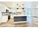 Modern kitchen featuring white cabinets, a kitchen island, and stainless steel appliances at 2213 E Janice Way, Phoenix, AZ 85022