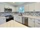 Updated kitchen showcasing white cabinets, stainless steel appliances, and a decorative tile backsplash at 2213 E Janice Way, Phoenix, AZ 85022