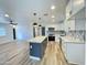 Modern kitchen featuring white cabinets, stainless steel appliances, and a gray island with a white countertop at 2213 E Janice Way, Phoenix, AZ 85022