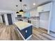 Well-lit kitchen featuring white cabinets, stainless steel appliances, and a quartz island at 2213 E Janice Way, Phoenix, AZ 85022