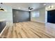 Bright living room featuring wood-look flooring, a accent wall, and a modern ceiling fan at 2213 E Janice Way, Phoenix, AZ 85022