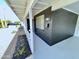 Inviting front porch with a black accent wall, a white railing, and updated landscaping at 2213 E Janice Way, Phoenix, AZ 85022