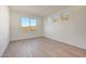 Bedroom with wood-look tile flooring, natural light, and three windows at 28958 N 174Th Ln, Surprise, AZ 85387