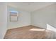 An empty bedroom with wood-look tile floors with a large window for natural light at 28958 N 174Th Ln, Surprise, AZ 85387