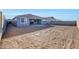 Back exterior view of grey home with a huge dirt backyard and cinder block fence at 28958 N 174Th Ln, Surprise, AZ 85387