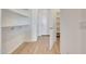 Hallway with built-in shelves and wood-look ceramic tile flooring at 28958 N 174Th Ln, Surprise, AZ 85387