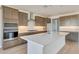 Modern kitchen with stainless steel appliances, a large island, and tile backsplash at 28958 N 174Th Ln, Surprise, AZ 85387