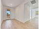 Neutral living room with wood-style tile floors, a large glass door, and access to other rooms at 28958 N 174Th Ln, Surprise, AZ 85387